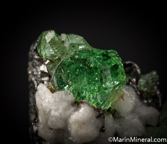 Tsavorite, Diopside, Calcite on Graphite from Merelani Hills, Arusha, Tanzania [db_pics/pics/J498c.jpg]