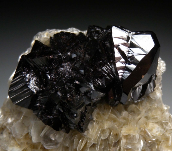 Cassiterite on Muscovite from Mt Xuebaoding, Ping Wu, Sichuan Prov., China [db_pics/pics/mk233c.jpg]