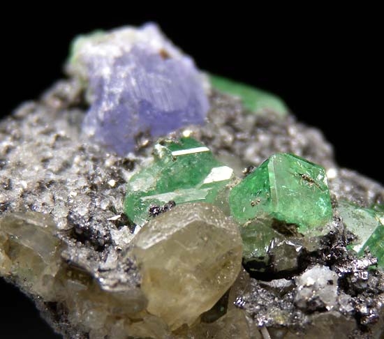 Tanzanite, Tsavorite, Diopside on Graphite from Merelani Hills, Arusha, Tanzania [db_pics/pics/t565c.jpg]